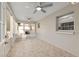 Enclosed sunroom with tile floors, ceiling fans, lots of windows, and a door to the outside at 8681 Sw 93Rd Pl # B, Ocala, FL 34481