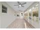 Relaxing sunroom with tile flooring, bright windows, and a ceiling fan at 8681 Sw 93Rd Pl # B, Ocala, FL 34481