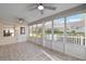 Light-filled sunroom with tile floors, ceiling fans, and large windows overlooking the backyard at 8681 Sw 93Rd Pl # B, Ocala, FL 34481