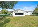 Well-maintained single-story home featuring a covered porch with white railing and a beautifully manicured green lawn at 8973 Sw 103Rd Ln, Ocala, FL 34481