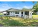 Charming home with a covered porch, tasteful decorations, and landscaping offering a welcoming curb appeal at 8973 Sw 103Rd Ln, Ocala, FL 34481