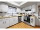 Bright kitchen with white cabinets, stainless steel appliances, and checkered backsplash accents at 8973 Sw 103Rd Ln, Ocala, FL 34481