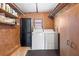 The laundry room has a washer, dryer, and black shelving unit at 8973 Sw 103Rd Ln, Ocala, FL 34481