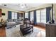 Inviting living room with a comfortable sofa, hardwood floors, and plenty of natural light at 8973 Sw 103Rd Ln, Ocala, FL 34481