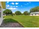 Green backyard with mature trees and view of other homes in neighborhood at 9330 Sw 84Th Ter # A, Ocala, FL 34481
