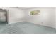 Bedroom with blue carpeting and a window overlooking mature landscaping at 9330 Sw 84Th Ter # A, Ocala, FL 34481
