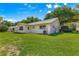 The exterior of the house showcases a well-maintained lawn and an AC unit at 9330 Sw 84Th Ter # A, Ocala, FL 34481