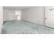 Spacious living room featuring light blue carpet and access to kitchen area at 9330 Sw 84Th Ter # A, Ocala, FL 34481