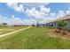 Wide view of backyard featuring mature trees and meticulous landscaping and fairway in the distance at 9577 Sw 82Nd Street Rd, Ocala, FL 34481