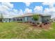 Landscaped backyard featuring a covered patio, healthy lawn, and privacy landscaping at 9577 Sw 82Nd Street Rd, Ocala, FL 34481