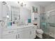 Modern bathroom featuring a shower with glass enclosure and quartz countertops at 9577 Sw 82Nd Street Rd, Ocala, FL 34481