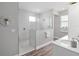 Modern bathroom featuring a glass-enclosed shower with marble-like tiling and white vanity at 9577 Sw 82Nd Street Rd, Ocala, FL 34481
