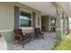 Inviting front porch with comfortable seating area overlooking the landscaped front yard at 9577 Sw 82Nd Street Rd, Ocala, FL 34481