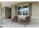 Comfortable seating area on the front porch with a view of the manicured front yard at 9577 Sw 82Nd Street Rd, Ocala, FL 34481