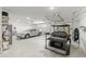 A clean, spacious garage featuring an electric car and a golf cart, with plenty of storage space at 9577 Sw 82Nd Street Rd, Ocala, FL 34481