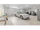 Spacious two-car garage with a car and golf cart, featuring ample storage and a utility sink at 9577 Sw 82Nd Street Rd, Ocala, FL 34481
