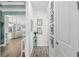 Hallway leading to an open-concept living space, featuring elegant trim and picture frame wall decor at 9577 Sw 82Nd Street Rd, Ocala, FL 34481