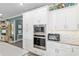 Kitchen featuring white cabinets, stainless appliances, gray countertops, and decor on top of the cabinets at 9577 Sw 82Nd Street Rd, Ocala, FL 34481