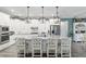 Bright, modern kitchen featuring a spacious island with barstool seating, stainless steel appliances and pendant lights at 9577 Sw 82Nd Street Rd, Ocala, FL 34481