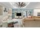 Bright living room with a ceiling fan, decorative furniture, and an open view into the entryway and kitchen at 9577 Sw 82Nd Street Rd, Ocala, FL 34481
