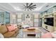 Comfortable living room featuring a ceiling fan, stylish furniture, and a decorative entertainment center at 9577 Sw 82Nd Street Rd, Ocala, FL 34481