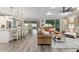 Open-concept living area with hardwood floors, a ceiling fan, and sliding glass doors to the outside at 9577 Sw 82Nd Street Rd, Ocala, FL 34481