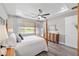 Bright and airy main bedroom featuring tray ceilings and a view of the golf course at 9577 Sw 82Nd Street Rd, Ocala, FL 34481