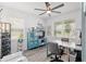 Bright office space featuring a ceiling fan, window views, and a stylish built-in storage unit at 9577 Sw 82Nd Street Rd, Ocala, FL 34481