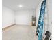 Unfinished storage room with concrete floors, a water heater and ladder at 9577 Sw 82Nd Street Rd, Ocala, FL 34481
