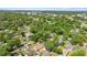 Aerial view of a residential neighborhood with mature trees and well-maintained lawns, close to a nearby highway at 1014 Ne 12Th St, Ocala, FL 34470
