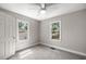Bright bedroom with carpet, two windows, and a ceiling fan at 1014 Ne 12Th St, Ocala, FL 34470
