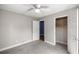 Bedroom with carpet, ceiling fan, closet, and two doors at 1014 Ne 12Th St, Ocala, FL 34470