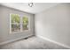 Small bedroom with carpet and a bright window looking to the backyard at 1014 Ne 12Th St, Ocala, FL 34470