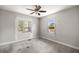 Neutral bedroom with carpet, ceiling fan, two windows, and unfinished drywall at 1014 Ne 12Th St, Ocala, FL 34470