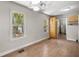 Bright dining room with wood-look floors, large windows, and a vintage chandelier at 1014 Ne 12Th St, Ocala, FL 34470