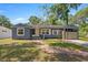 Charming single-story home with blue siding and a brick walkway, inviting curb appeal at 1014 Ne 12Th St, Ocala, FL 34470