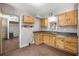 Cozy kitchen featuring wooden cabinets, a tiled floor, and a view into the next room at 1014 Ne 12Th St, Ocala, FL 34470