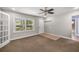 Bright living room featuring carpet floors, ceiling fan, and natural light at 1014 Ne 12Th St, Ocala, FL 34470