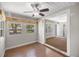 Bedroom with wood floors, ceiling fan, and doorway with shelving at 1014 Ne 12Th St, Ocala, FL 34470