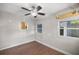 Bedroom features wood floors, ceiling fan, and two windows at 1014 Ne 12Th St, Ocala, FL 34470