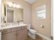 Bathroom featuring a single sink vanity, wood-look tile floor, and a window at 10451 Sw 98Th Place Rd, Ocala, FL 34481