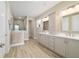 Bright bathroom featuring double sinks, drawers for storage, and a spacious shower at 10451 Sw 98Th Place Rd, Ocala, FL 34481
