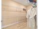 Walk-in closet featuring wood-look tile, wire shelving, and a bathrobe at 10451 Sw 98Th Place Rd, Ocala, FL 34481