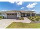Charming one-story home featuring a brick driveway, a two-car garage, and well-manicured landscaping at 10451 Sw 98Th Place Rd, Ocala, FL 34481