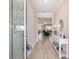 Bright foyer with wood-look tile flooring and a console table, leading to the living area at 10451 Sw 98Th Place Rd, Ocala, FL 34481