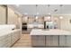 Open kitchen with stainless steel appliances, quartz countertops, and a large island at 10451 Sw 98Th Place Rd, Ocala, FL 34481
