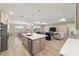 Open kitchen with a large island, stainless steel appliances, and a view of the dining and living areas at 10451 Sw 98Th Place Rd, Ocala, FL 34481