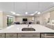 Modern kitchen island featuring a stainless steel sink and luxurious quartz countertop at 10451 Sw 98Th Place Rd, Ocala, FL 34481