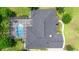 Aerial view of the property featuring a screened pool, landscaping, and newer roof at 1107 Se 49Th Ave, Ocala, FL 34471