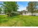 Picture of a home's spacious backyard with a screened-in pool area and a fire pit, perfect for outdoor gatherings at 1107 Se 49Th Ave, Ocala, FL 34471